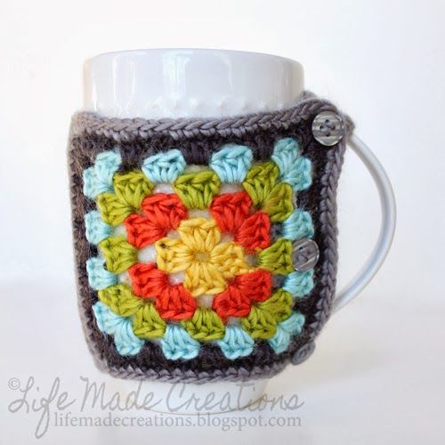 a crocheted coffee cup holder with a white mug in the shape of a flower