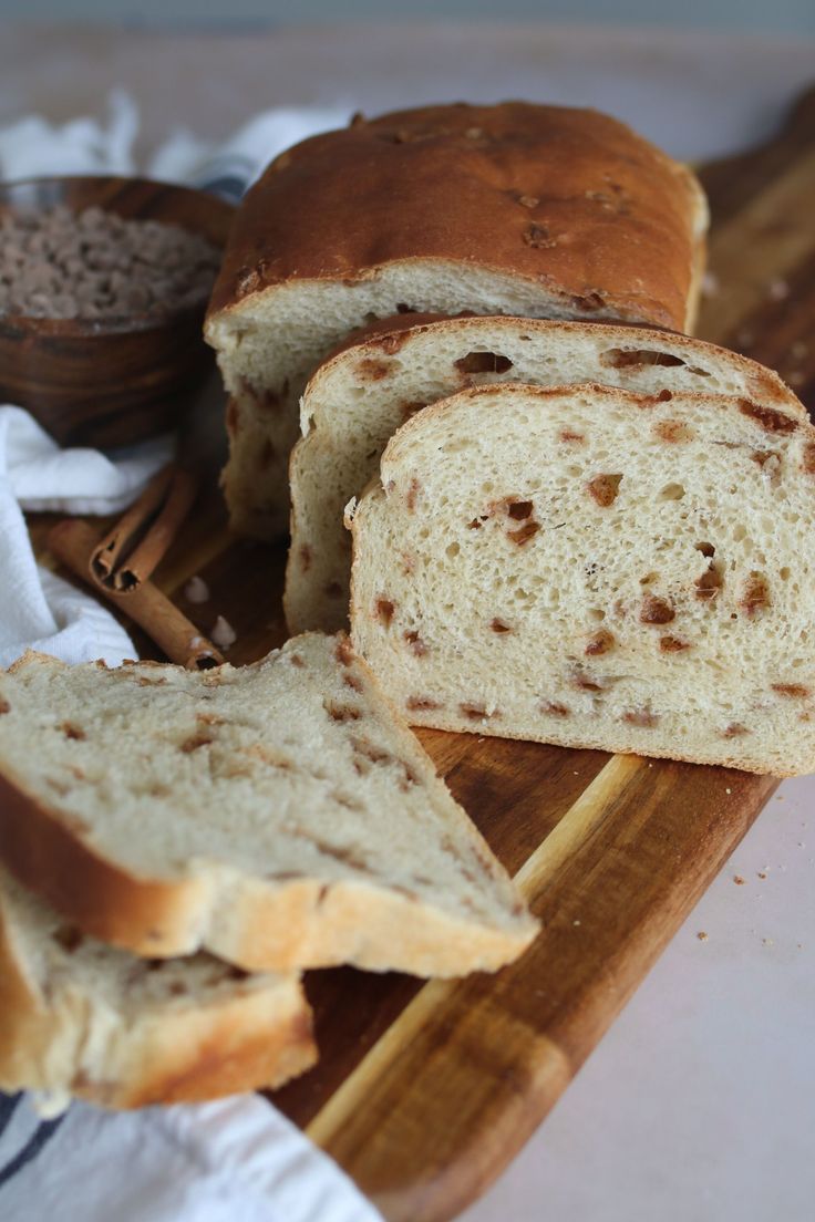 a loaf of bread sitting on top of a wooden cutting board