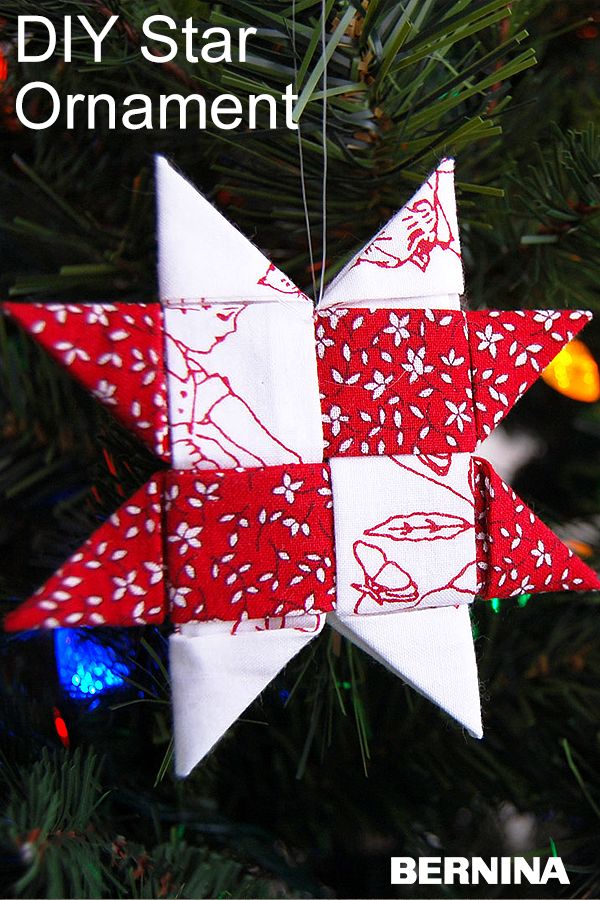 a red and white ornament hanging from a christmas tree with the words diy star ornament on it