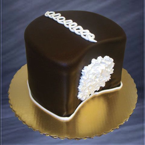 a chocolate cake with white frosting on a gold plate