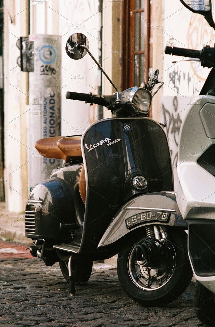 a scooter parked on the street in front of a building