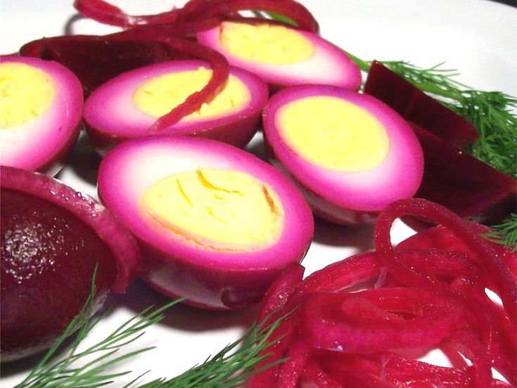 sliced beets and onions on a plate with dill sprigs next to them