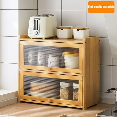 a microwave and toaster on top of a wooden cabinet