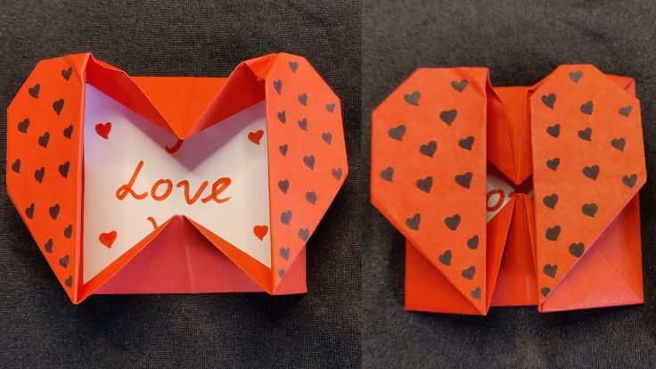 an origami heart with the word love written on it and folded in half