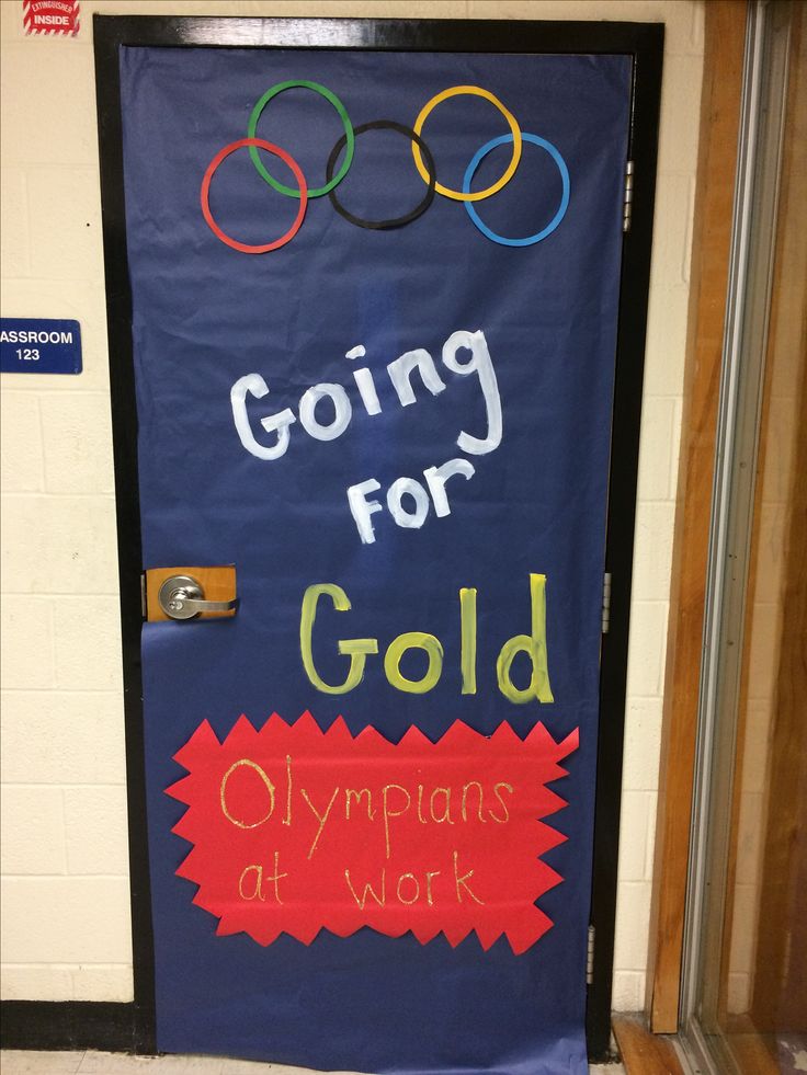 a door decorated with the olympic symbol and words going for gold, olympics at work