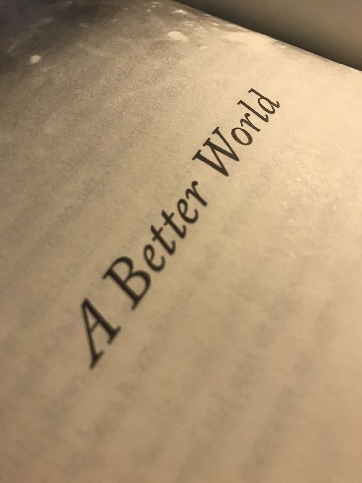 the word'a better world'written in black ink on an open book