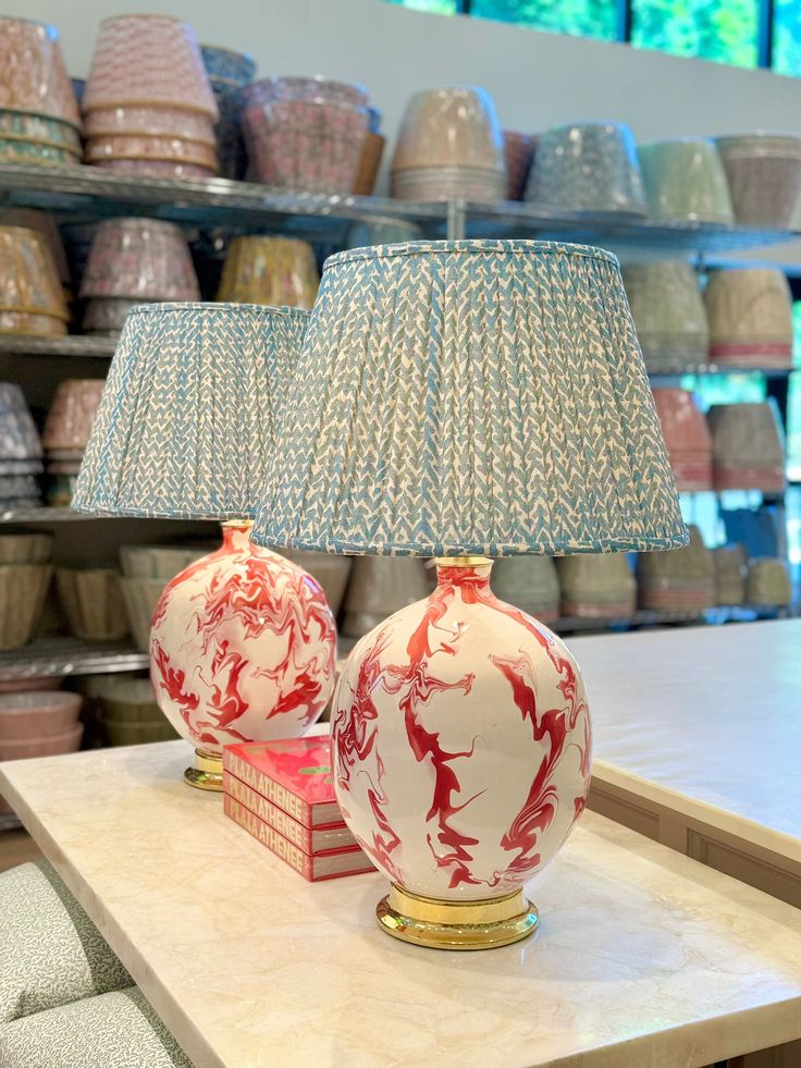 two red and white lamps sitting on top of a table