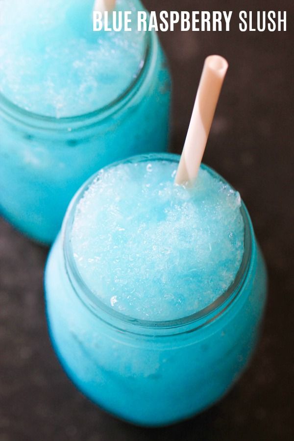 two blue raspberry slush drinks in mason jars with straws on top