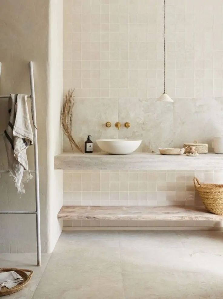 a bathroom with a sink, mirror and towel rack on the wall next to it