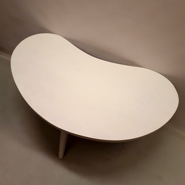 a white table sitting on top of a floor