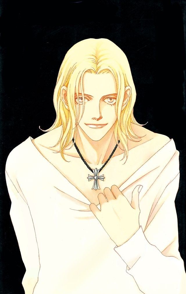 a man with long blonde hair wearing a white shirt and black beaded necklace, standing in front of a black background