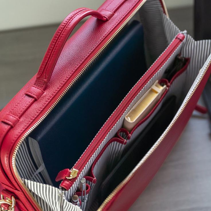 Named by Reader’s Digest as “one of the most stylish and functional work bags you’ll want to bring everywhere,” this business briefcase is an executive solution for smart organization. Its gusseted opening reveals the front organizational panel, with two pen sleeves and pockets for small items, and a dividing zippered section for slightly larger items. The back compartment can comfortably hold files, a notebook and a 15" laptop, with two bottom balance bars to hold the laptop in place. Unzip the Modern Rectangular Laptop Bag For Business Trips, Modern Briefcase For Business Trips, Modern Briefcase With Zipper Closure For Formal Use, Functional Leather Briefcase For Work, Classic Travel Briefcase With Laptop Sleeve, Functional Leather Briefcase For Office, Functional Leather Office Briefcase, Functional Business Laptop Bag With Sleeve, Functional Business Laptop Bag With Laptop Sleeve