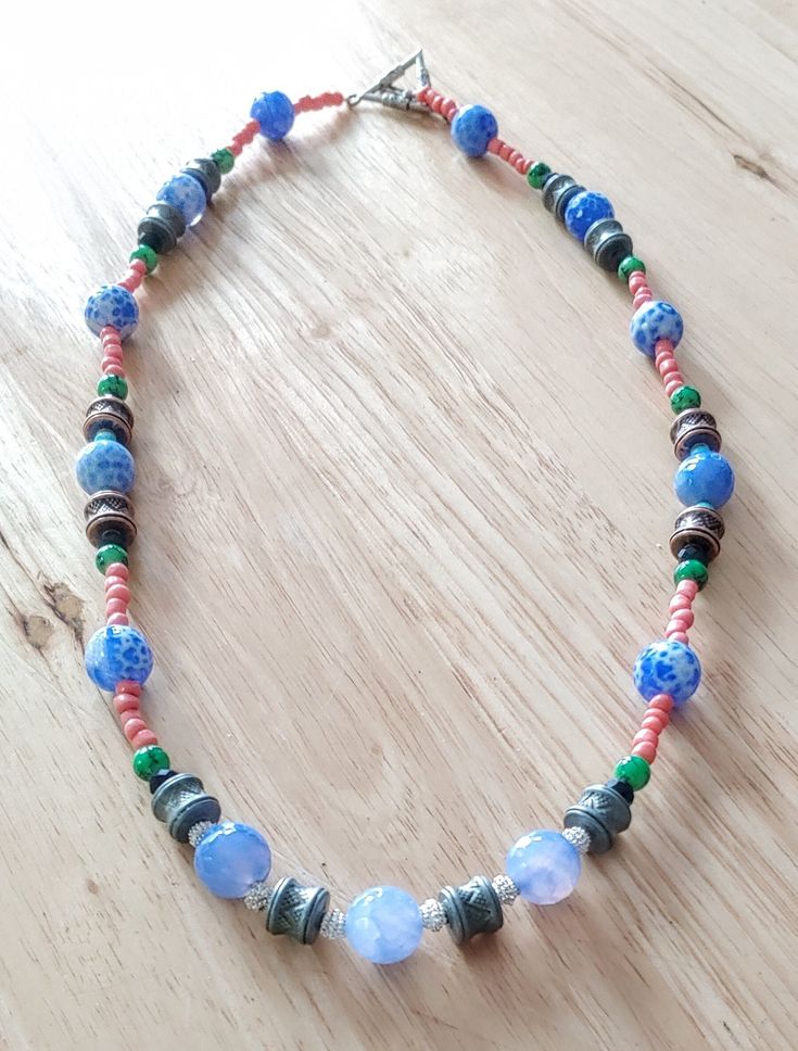 This necklace is made with periwinkle beads, green pearls, pink seed beads, blue pearls, black bicone crystal beads, and silver spacer beads. Toggle clasp. Measures 24 inches long end to end. Blue Pearls, Green Pearls, Blue Pearl, Toggle Clasp, Spacer Beads, Crystal Beads, Seed Beads, Necklace Etsy, Graffiti