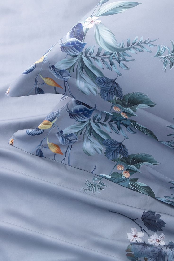 the sheets and pillow cases are covered with blue flowers