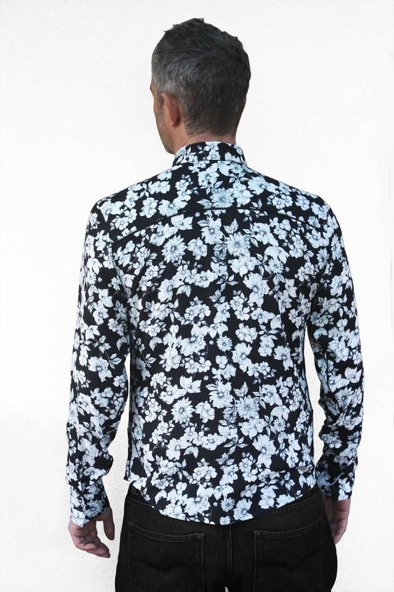 Mens black floral shirt, made out of soft viscose rayon. Gray big flowers print on black background. Shoulders, collar& cuff lining with black & white dots. Black piping. Black button. Comes with an assorted fabric pouch. Limited edition. S :Chest : 40 ¼ " / 102 cm Waist : 35 ¾ " / 91 cmBuild : 17 ¼ "  / 44 cmBack height : 29 ½ " / 74 cmSleeves length : : 26 ¾ " / 68 cmArm circumference : 15 " / 38 cmNeck size : 15 ¾ " / 40 cmM :Chest : 4 1 ¾ " / 106 cmWaist : 37 ¾ " / 96 cmBuild : 17  ¾ Black Floral Print Shirt For Summer, Black Collared Top With Floral Print, Black Collared Floral Print Top, Black Floral Print Collared Top, Fitted Floral Print Patterned Shirt, Fitted Collared Shirt With Floral Print, Black Floral Shirt, Navy Flowers, Fabric Pouch