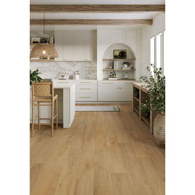 a kitchen with wood floors and white cabinets