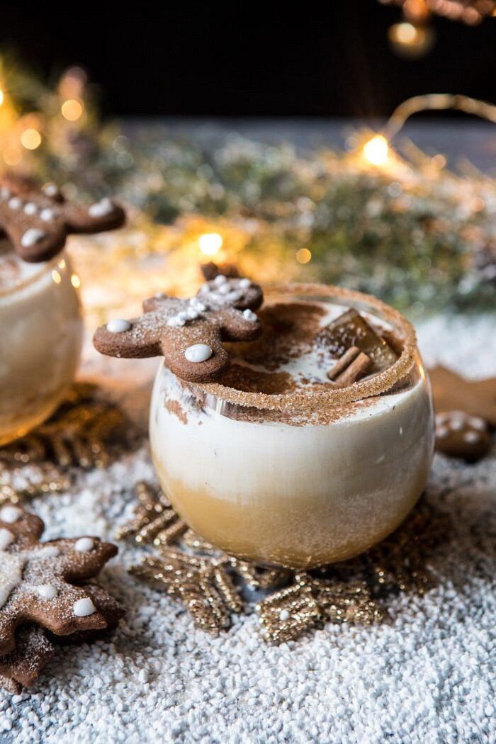 two small bowls filled with cookies on top of snow covered ground next to christmas lights