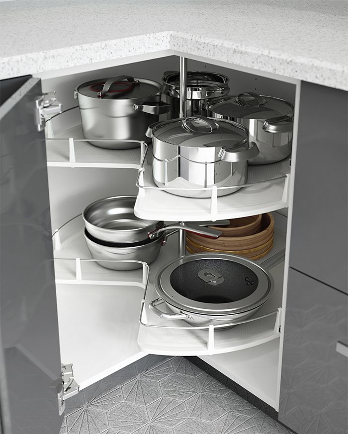 an open cabinet with pots and pans in it