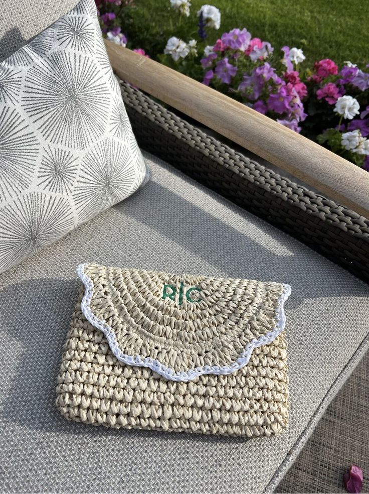 Scalloped detailing and straw come together to create the ultimate warm-weather clutch. Pair it with your favorite vacation outfit for a playful statement piece or use it for extra organization in your beach bag. Features a magnetic snap closure and a cotton lining with a zipper pocket to keep small items like lipstick and keys secure. Add a custom monogram to put your own spin on the design. Makes a wonderful gift for bridesmaids, birthdays, and more. Features: • 10.5”w x 1”d x 6.5”h• Interior Woven Rectangular Clutch For Summer, Rectangular Woven Clutch For Summer, Chic Summer Crochet Pouch Bag, Everyday Summer Straw Clutch, Chic Summer Woven Clutch, Eco-friendly Summer Straw Pouch Bag, Summer Woven Straw Pouch Bag, Spring Travel Clutch With Woven Details, Summer Straw Clutch