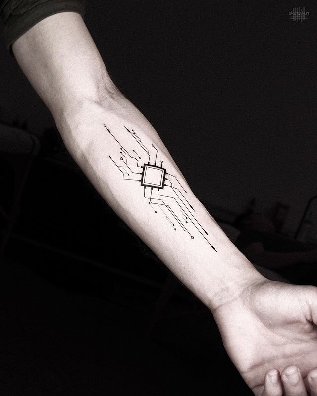 a person's arm with a computer chip tattoo on it