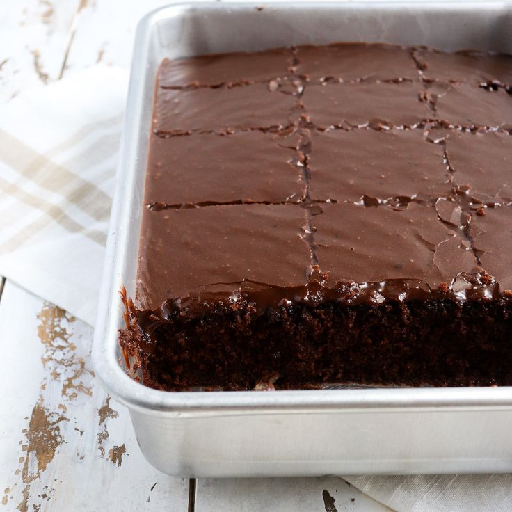 a pan filled with chocolate cake sitting on top of a table