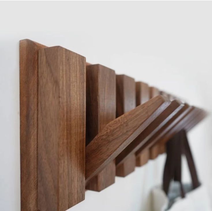 a wooden coat rack hanging on the wall