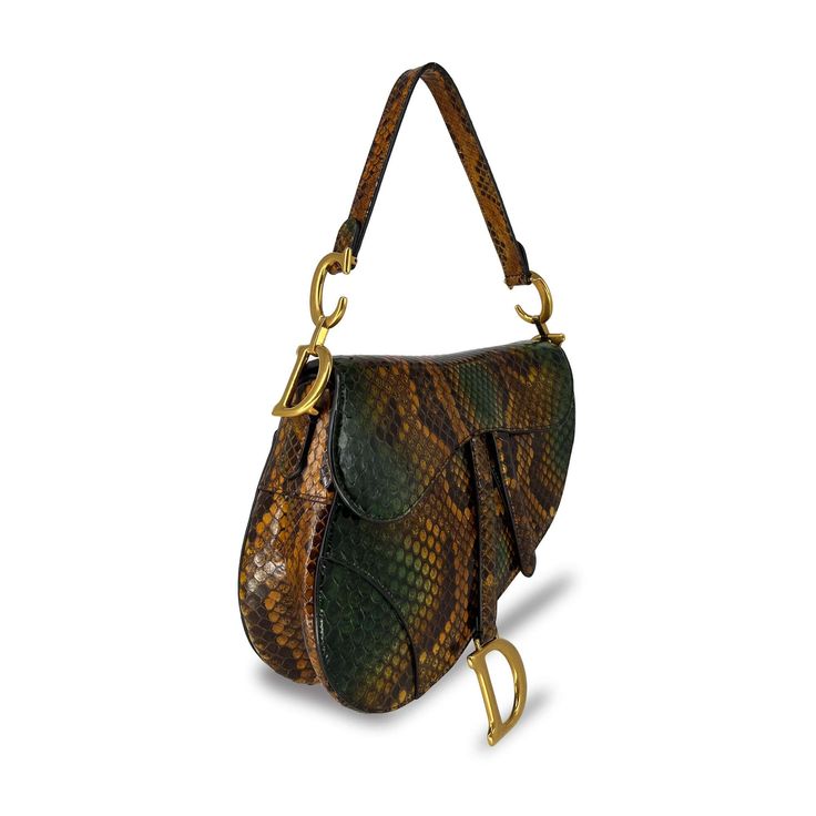 Want a more iconic version of everone's favourite Dior saddle bag? The Dior saddle bag in python skin is what you are looking for. The brown and green colours naturally along with the gold hardware naturally enhance your outfit's elegance. Condition: Brand new Comes with: Dust bag and box Colour: Python print (brown, green) Size: Large Item not able Blue Mermaid Dress, Bag Wardrobe, Green Colours, Luxury Bags Collection, Python Skin, Dior Saddle, Bag Inspiration, Blue Mermaid, Girly Bags