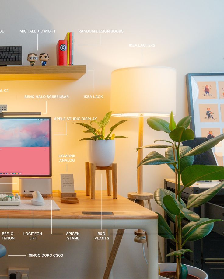 a desk with a computer monitor, keyboard and mouse on it next to a potted plant