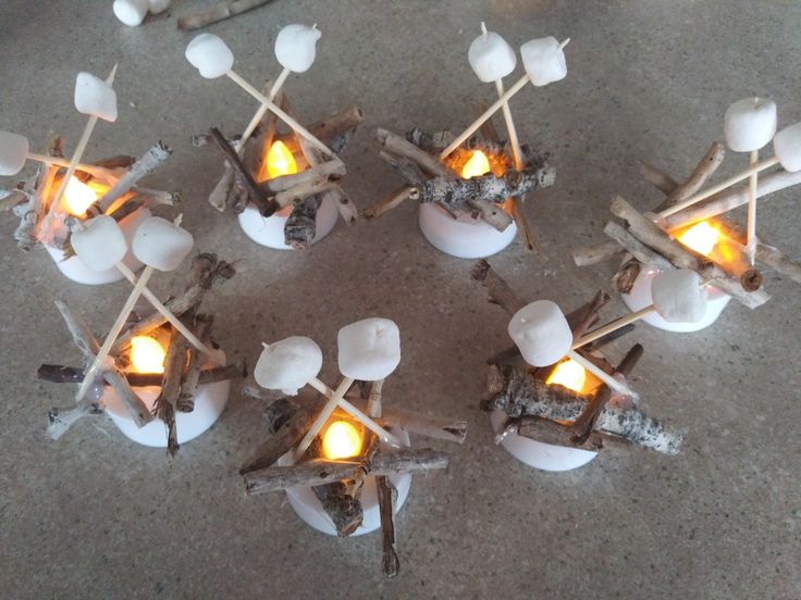 several marshmallows are cooking over an open fire with sticks sticking out of them