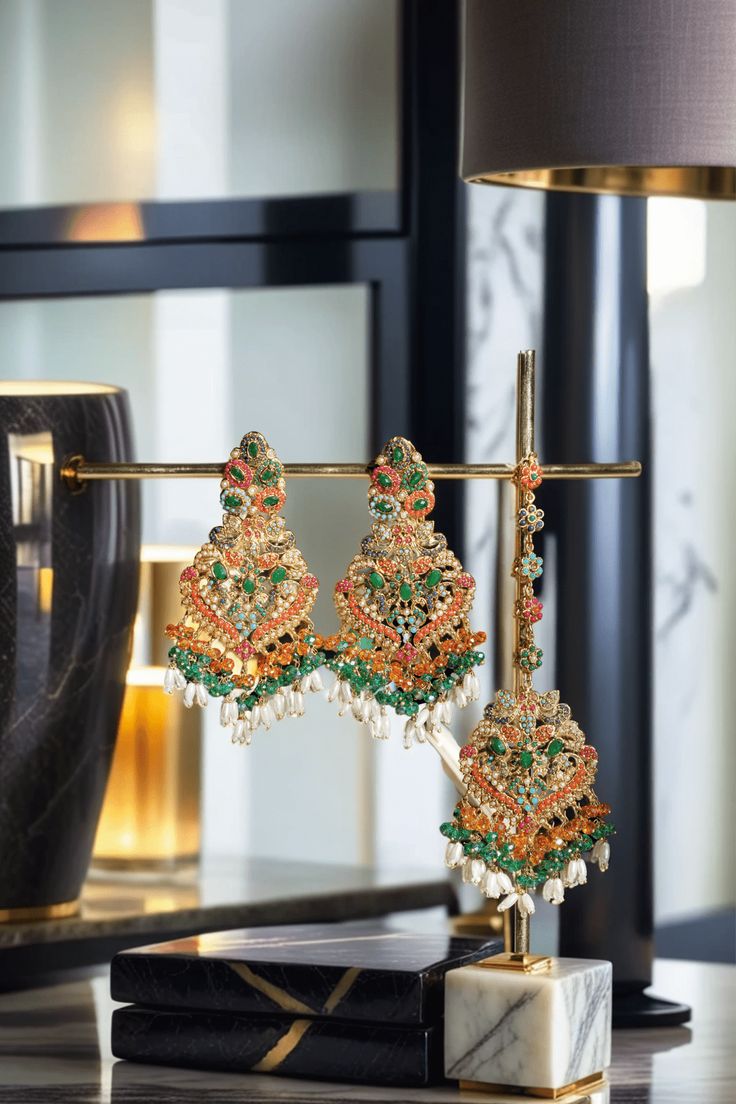 Elevate your festive attire to dreamy perfection with the Sarah - Chandelier Earrings & Maang Tikka Set, an embodiment of grandeur and allure. This exquisite earrings & maang tikka set is meticulously embellished with the splendor of multi-color stones and embellishments, adding a touch of magic to your look. The set includes a pair of stunning chandelier earrings and a maang tikka, each designed to captivate. With an approximate earring length of 3.5 inches, they are a symbol of elegance and op Fusion Style Kundan Danglers For Festive Occasions, Festive Fusion Kundan Danglers, Fusion Style Hand Set Chandelier Earrings For Party, Festive Temple Jewelry Chandelier Dangle Earrings, Fusion Kundan Chandelier Earrings With Latkans, Fusion Style Kundan Chandelier Earrings With Latkans, Temple Jewelry Style Chandelier Earrings For Wedding And Diwali, Festive Fusion Chandelier Drop Earrings, Festive Hand-set Chandelier Drop Earrings