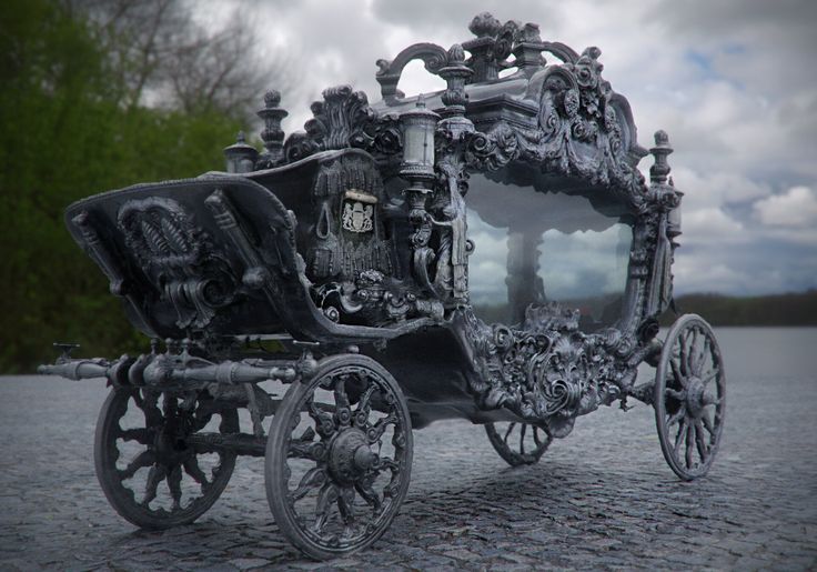 an elaborately decorated horse drawn carriage on gravel