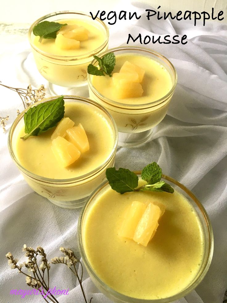 three glasses filled with pudding and garnished with green leaves