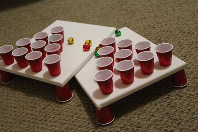 two trays filled with cups sitting on top of a carpeted floor next to each other