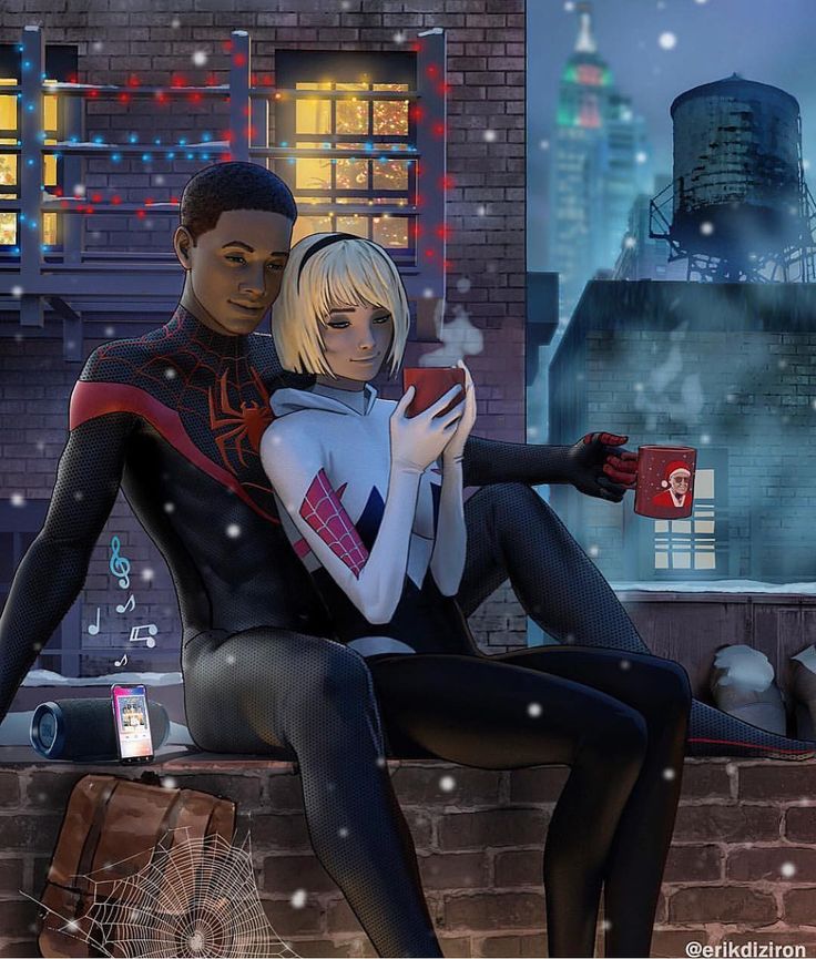 a man and woman sitting next to each other on top of a building in the snow