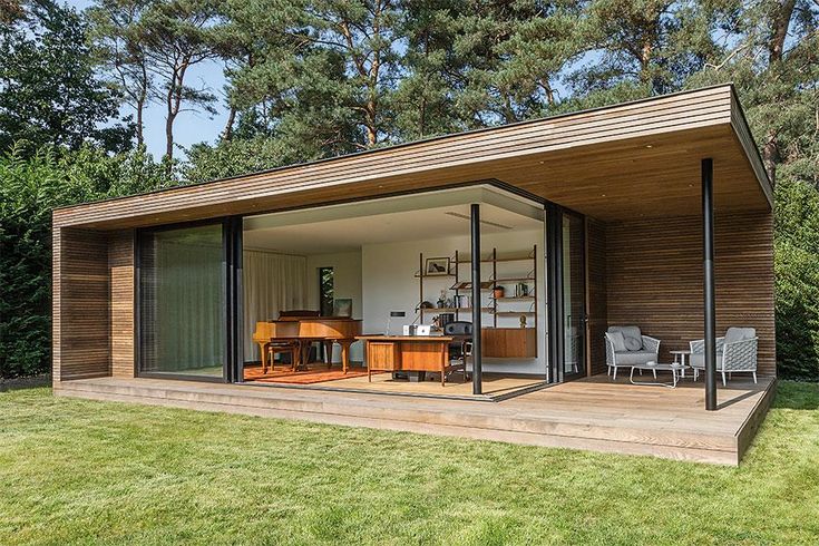 an outdoor room with sliding glass doors on the outside and wood sidings on the inside