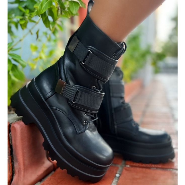 Introducing A Fierce Blend Of Style And Functionality: The Black Vegan Leather Combat Biker Boot. Crafted With Attention To Detail, These Boots Boast A Rugged Lace-Up Design Complemented By Adjustable Straps, Ensuring A Personalized Fit And Edgy Flair. The Chunky Lug Sole And Heel, Standing At Approximately 3 Inches, Provide Both Stability And A Bold Statement, Making These Boots The Perfect Choice For The Modern Woman Ready To Conquer Any Terrain With Confidence And Style. - Black Vegan Leather - Combat Biker Boot - Lace Up - Adjustable Straps - Chunky Lug Sole & Heel, Approx. 3" True Size Trendy Black Platform Moto Boots, Trendy Buckle Closure Boots For Streetwear, Black Platform Moto Boots For Spring, Edgy Spring Moto Boots With Platform, Trendy Black High Ankle Combat Boots, Black Combat Boots With Buckle For Streetwear, Edgy Black Moto Boots With Chunky Platform, Trendy Black Combat Boots With Chunky Platform, Spring Platform Moto Boots For Streetwear