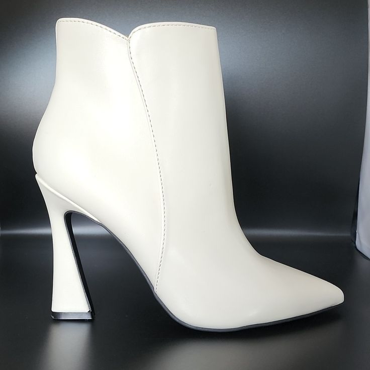 A Off-White High Heel And Pointy Toe. Never Worn. Heel Height: 3.94" Shaft Height (Boots): 2.75" Shaft Circumference (Boots): 9.44" Toe Type: Pointy Upper Material: Leather Outsole Material: Manmade Lining Material: Synthetic Product Collection: Bootie White Heeled Boots With Sculpted Heel And Medium Width, White Medium Width Closed Toe Heeled Boots, Chic White Closed Toe Heeled Boots, Formal White Heeled Boots With Sculpted Heel, White Boots With 4-inch Heel And Round Toe, White Pointed Toe Heeled Boots With Medium Width, White Heeled Boots With Sculpted Heel, White High Ankle Boots With Sculpted Heel, White High Heeled Boots With Sculpted Heel