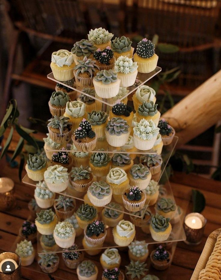 cupcakes are stacked on top of each other in the shape of a tree