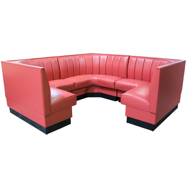 a red leather corner sofa sitting on top of a white floor