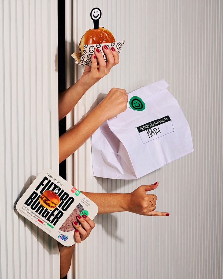 two women holding donuts and paper bags with stickers on them