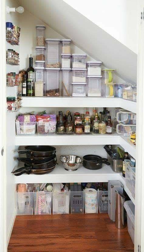 an organized pantry under the stairs