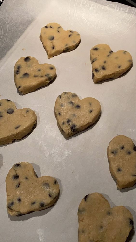 heart shaped cookies on a baking sheet ready for the oven to bake in an oven