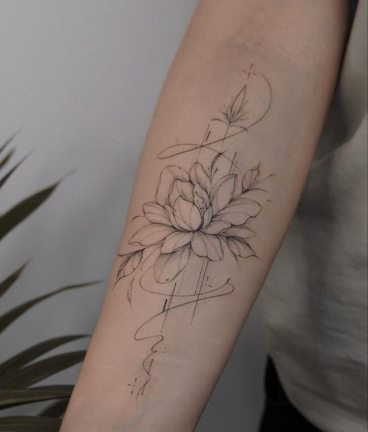 a woman's arm with a flower tattoo on it