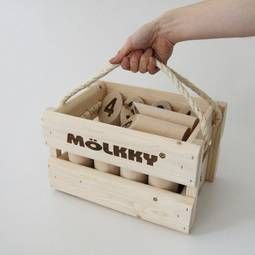 a person is holding a wooden crate with four bottles in it