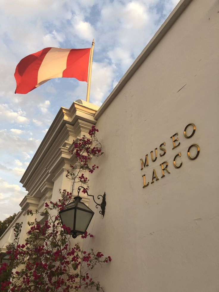 a red and white flag on top of a building