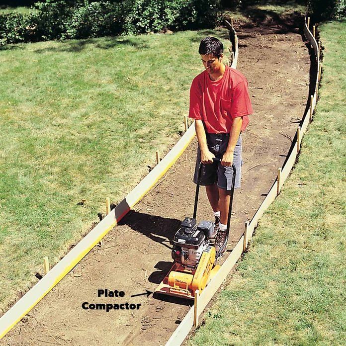 a man is using a machine to lay the ground