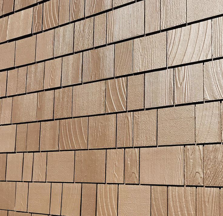 the side of a brown brick building with woodgrains