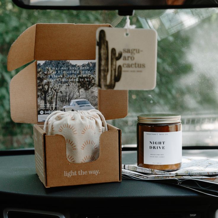 the inside of a car with two boxes on top of it and a jar of honey