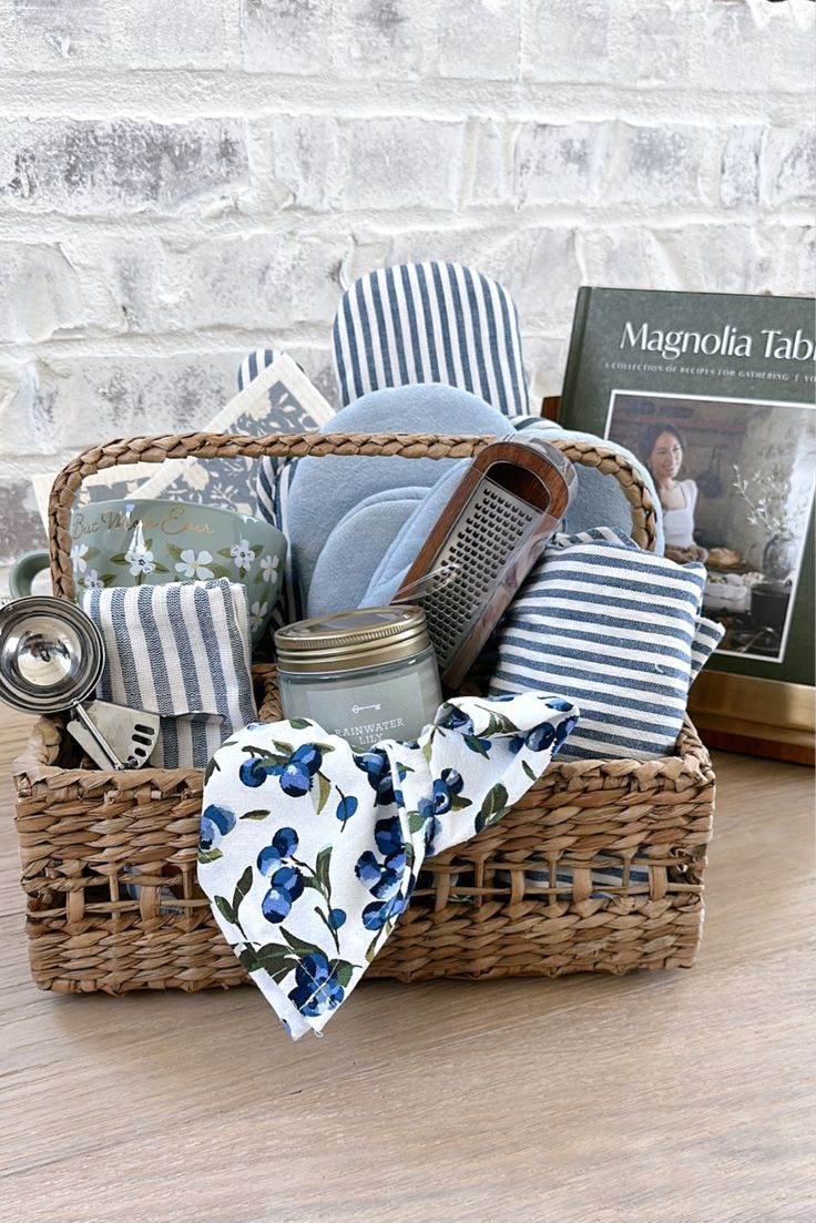 a basket filled with items sitting on top of a wooden table next to a book