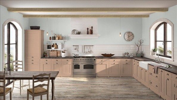 a kitchen with pink walls and white cabinets is pictured in this image, there are chairs around the table